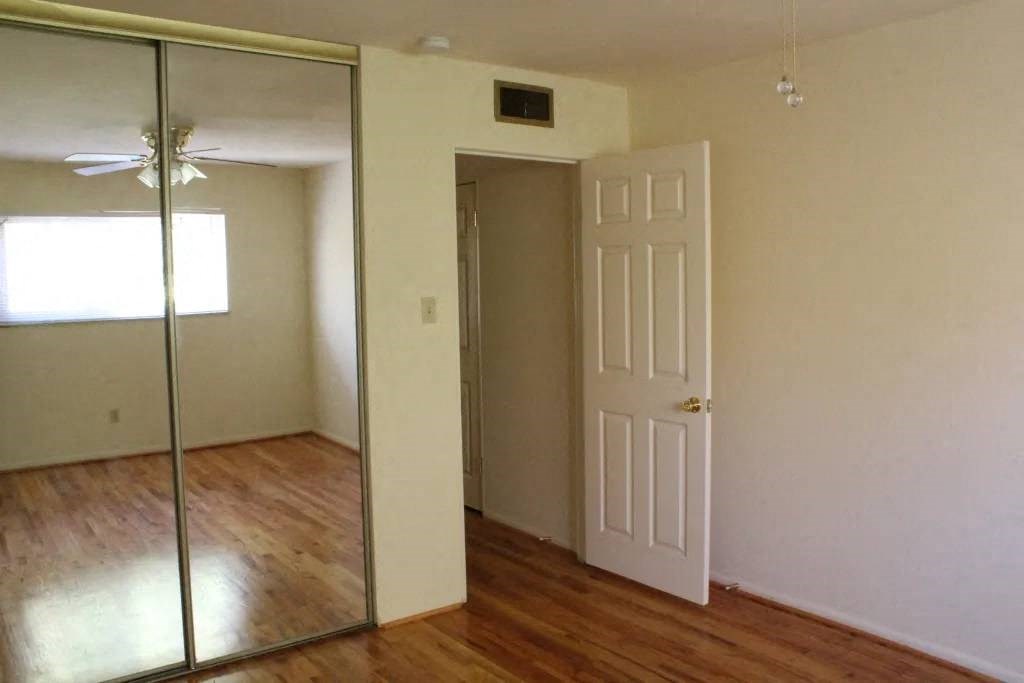 an empty room with a mirror and a door