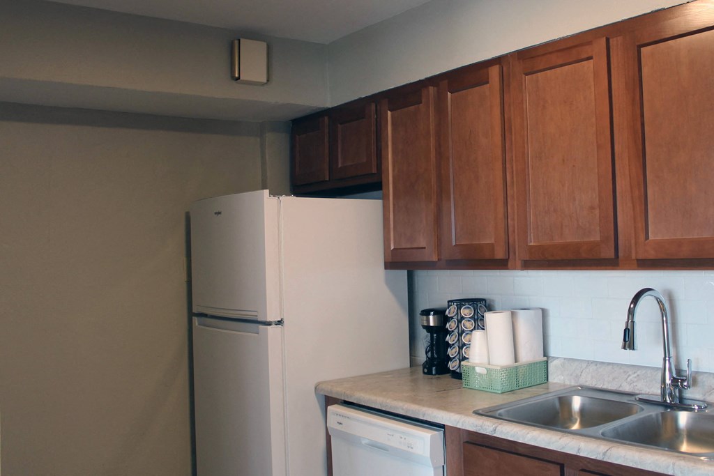 a kitchen with a sink and a refrigerator