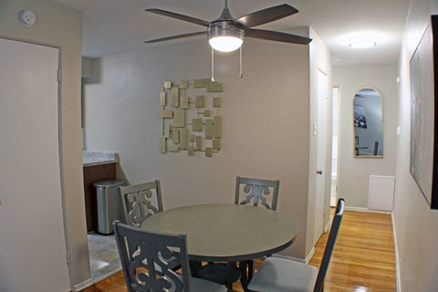 a dining room with a table and a ceiling fan