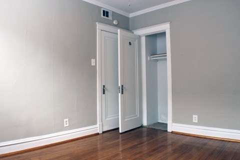 A room with two doors and a shelf.