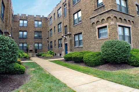 A brick building with a walkway in front.