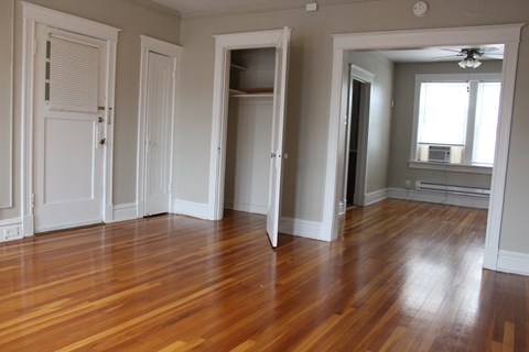 A room with wooden floors and white walls.