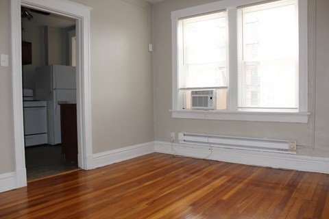 A room with a window and a radiator on the wall.