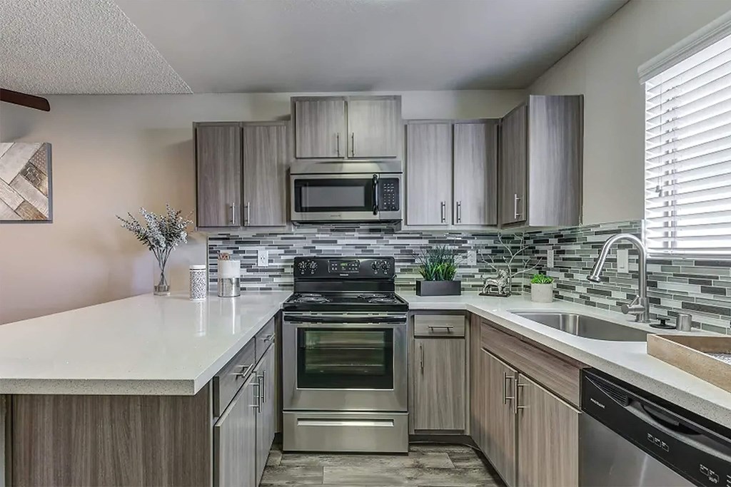 a kitchen with stainless steel appliances and wooden cabinets