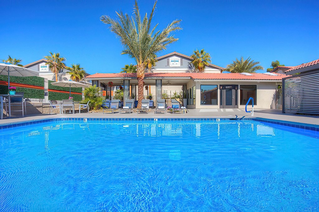 a large swimming pool in front of a house