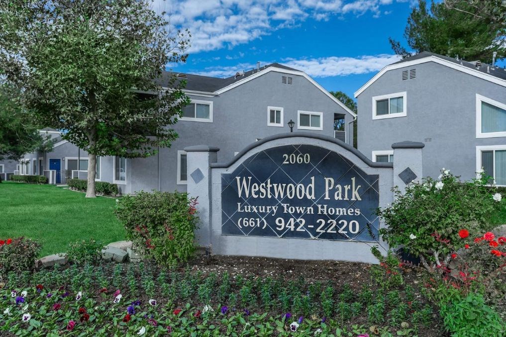 a sign for westwood park in front of an apartment building