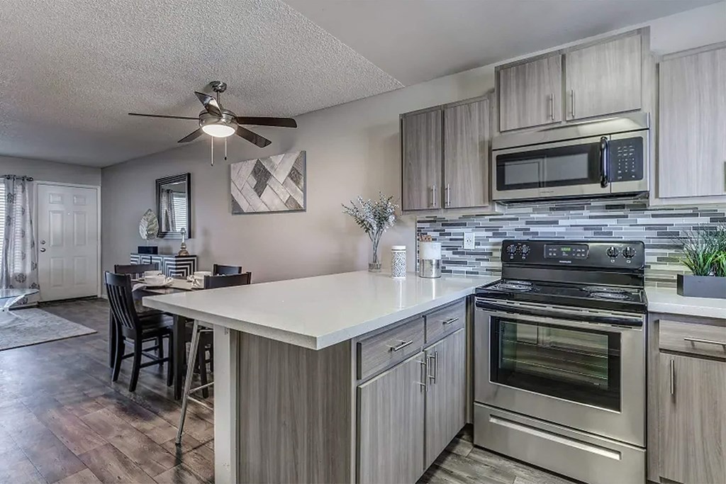 a kitchen with stainless steel appliances and a counter top