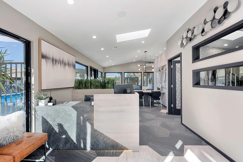 a lobby with a reception desk and a table with chairs