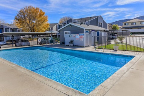 a swimming pool with a house in the background