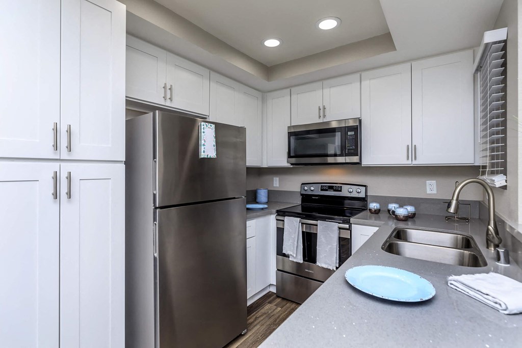 a kitchen with stainless steel appliances and white cabinets