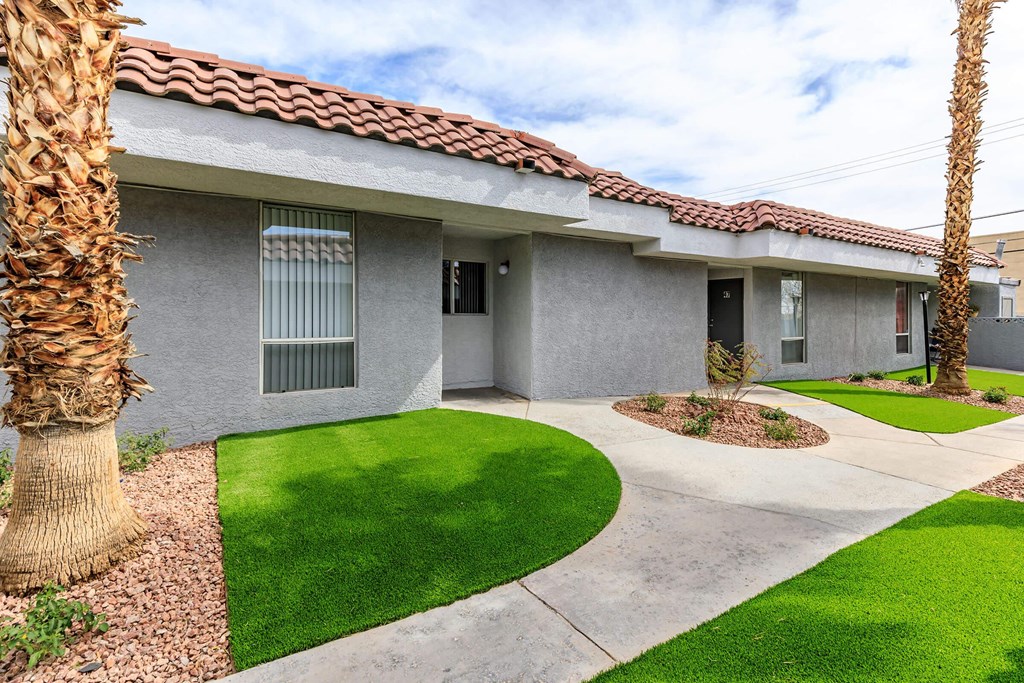 the front of a house with a yard and grass