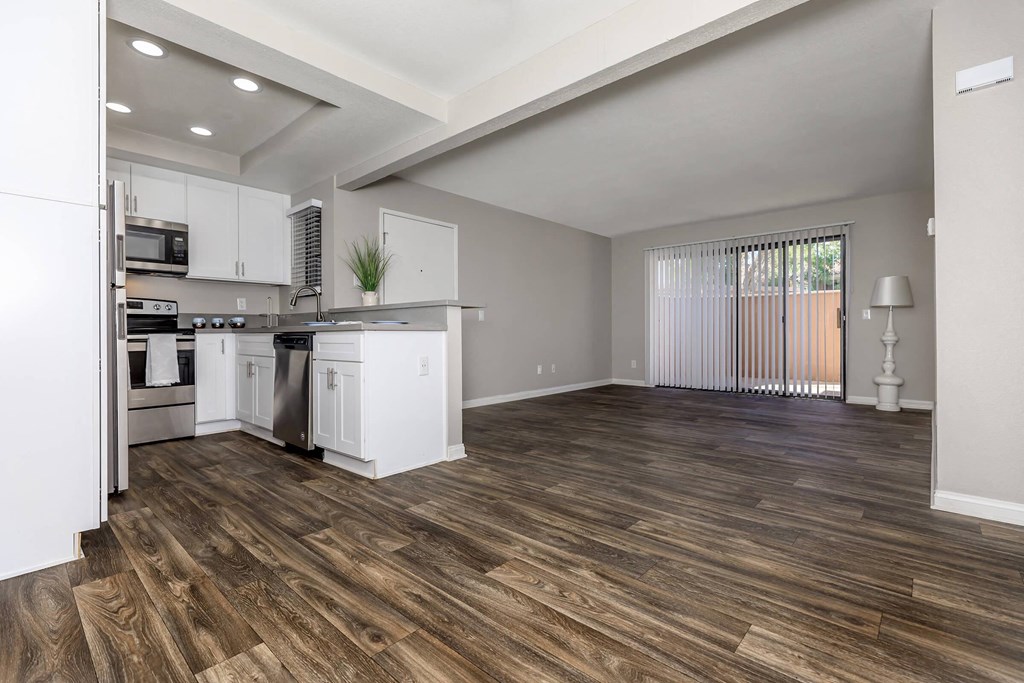 an open kitchen and living room with a large window and