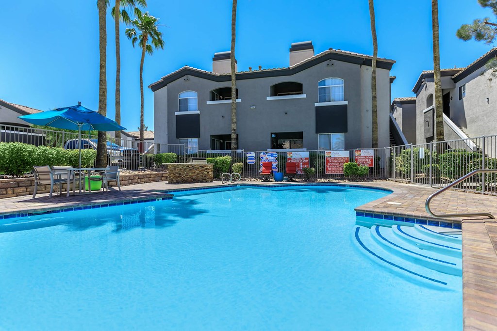 a large swimming pool with a building in the background