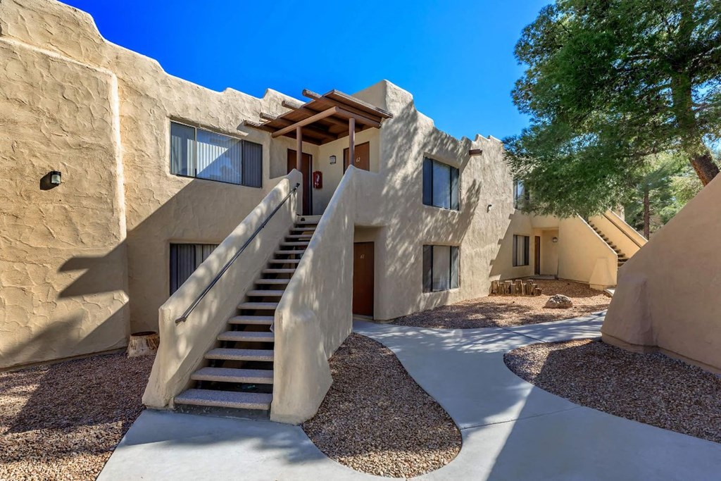 A modern house with a staircase leading to the entrance.