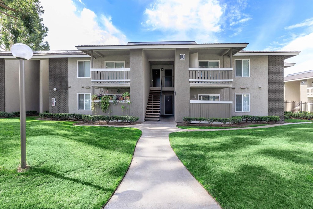 a large house with a yard and a sidewalk in front of it