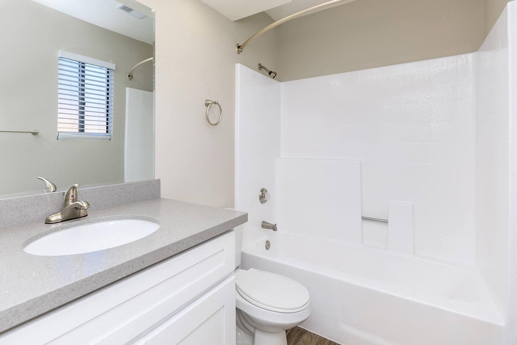 a bathroom with a sink toilet and a tub