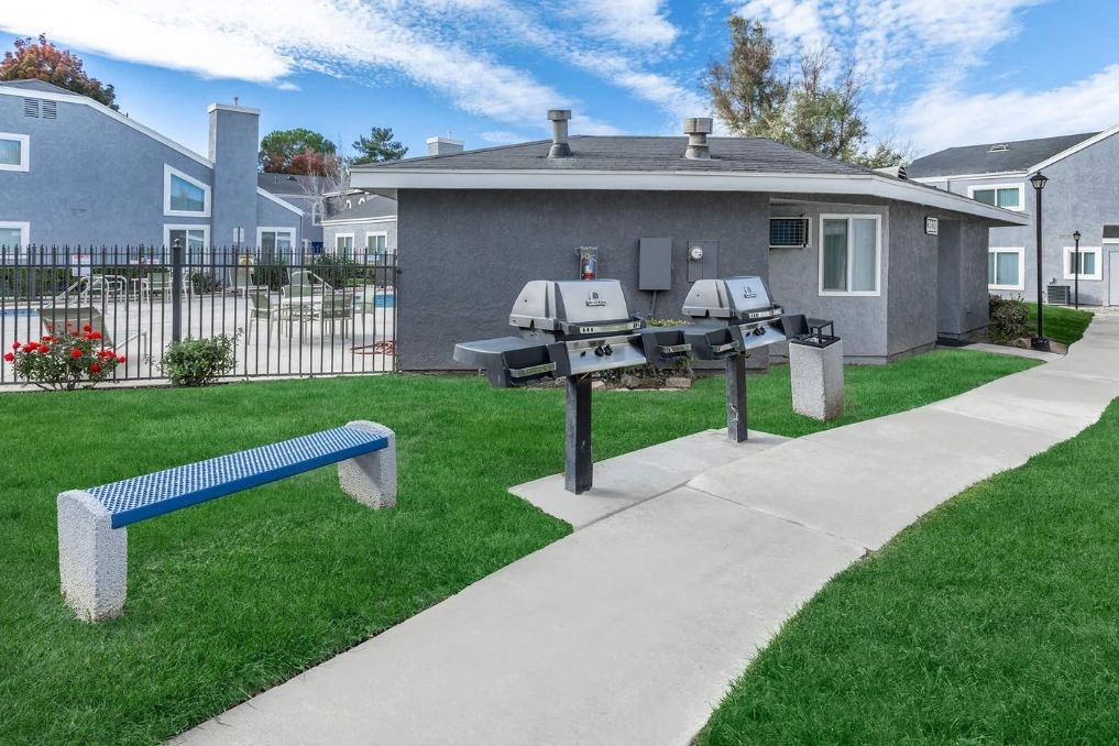 two mailboxes on a sidewalk in front of a house