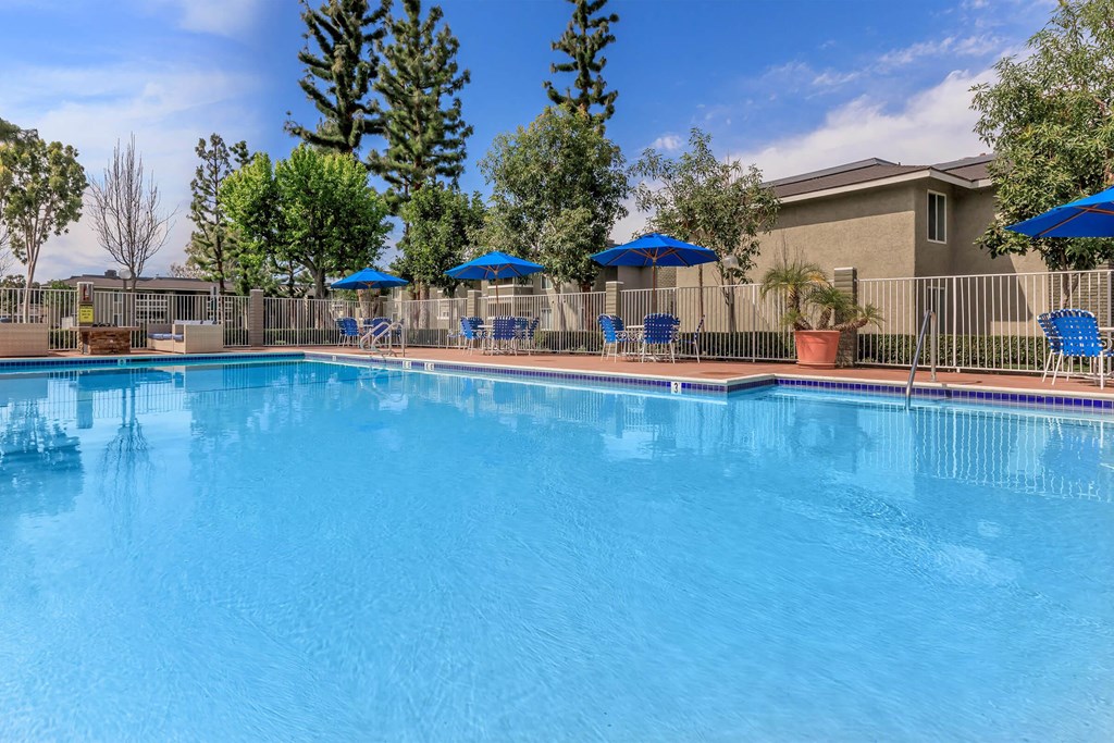 our resort style swimming pool is next to our apartments with umbrellas
