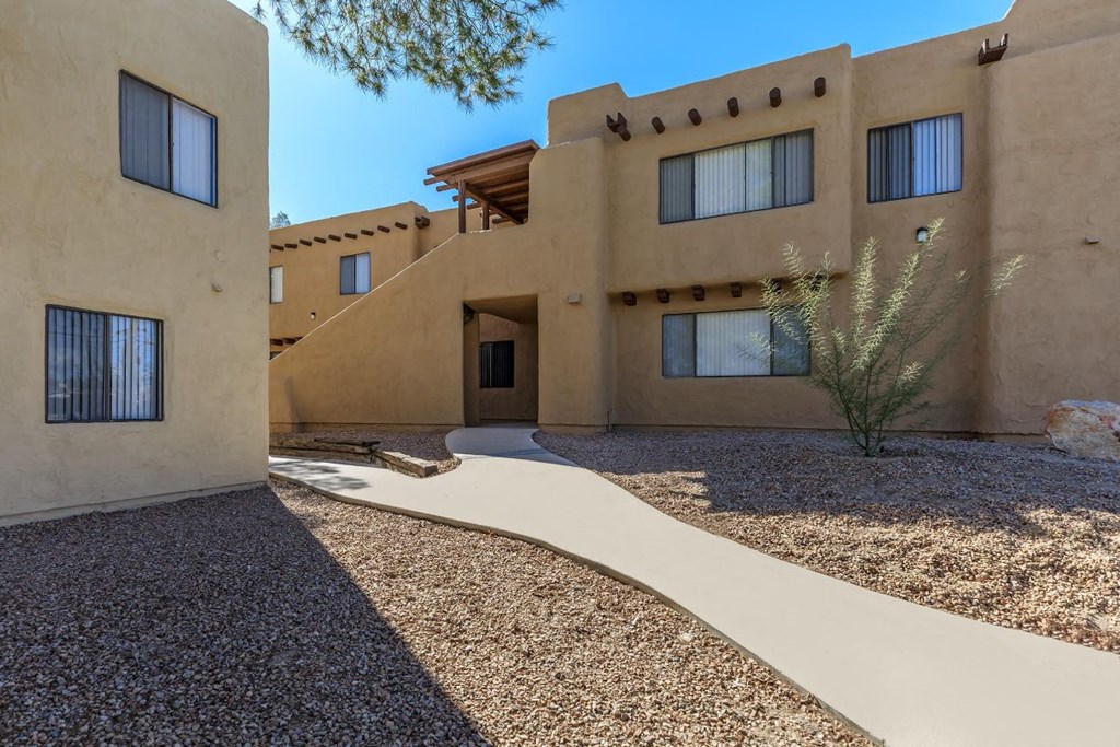 A building with a brown exterior and a white walkway in front.