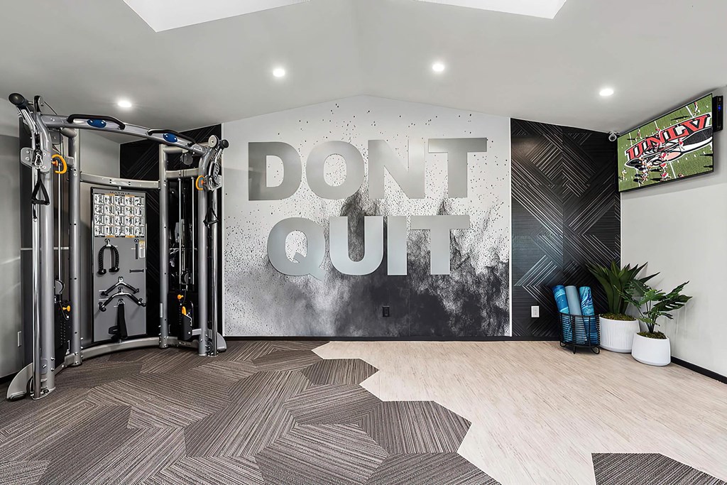 a gym with a wall that says dont quit on it