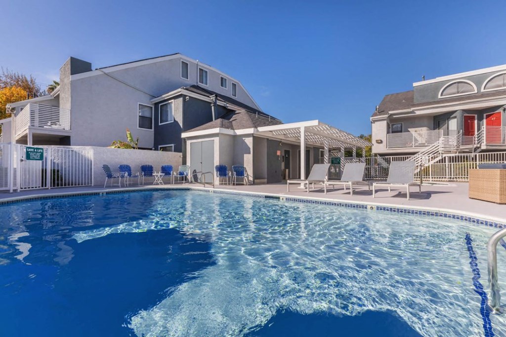 a swimming pool with a house in the background