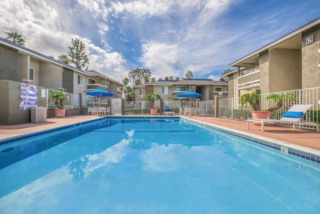 our apartments have a swimming pool and a patio with chairs