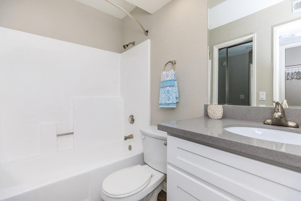a white bathroom with a sink and a toilet