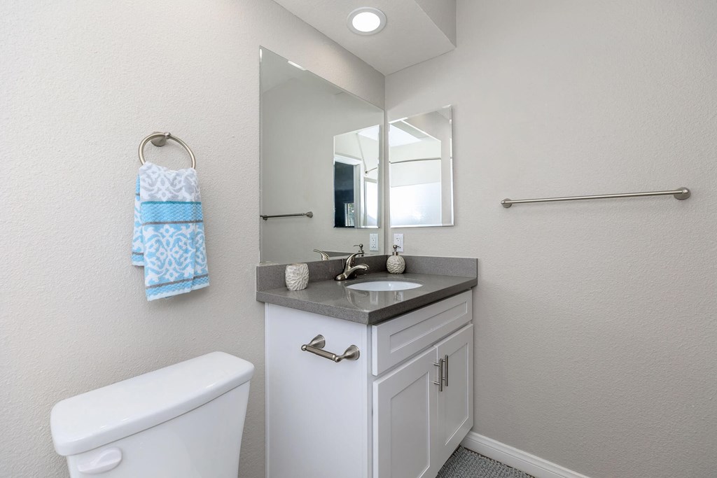 a white bathroom with a sink and a mirror