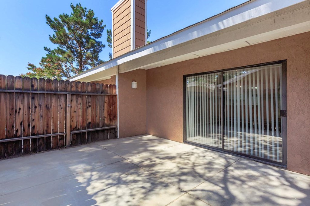 the entrance to a patio with a gate and a fence
