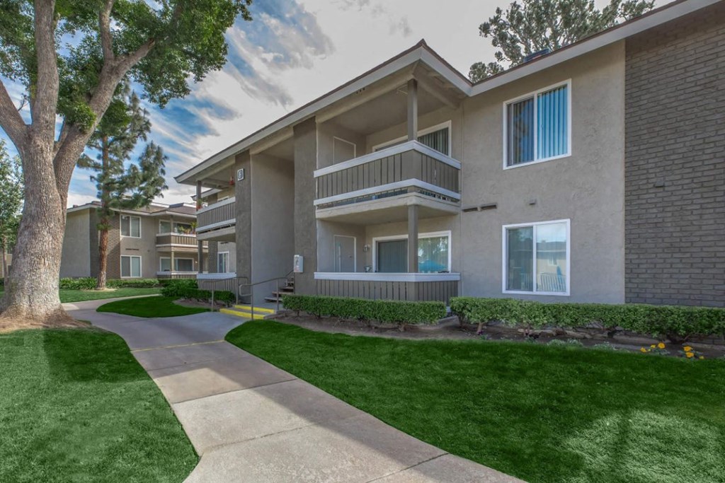 our apartments offer a walkway to the street with grass