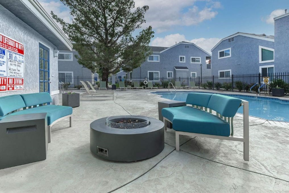 our apartments have a large patio with a fire pit and chairs