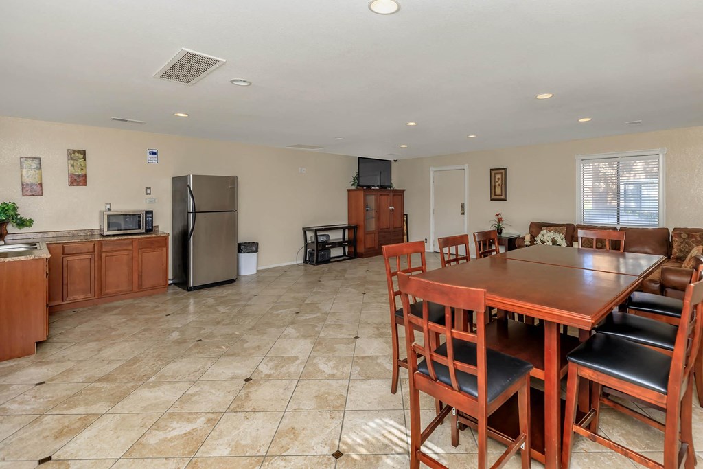 a kitchen and dining room with a wooden table and chairs