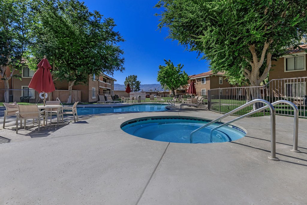 our apartments have a resort style pool with chairs and trees