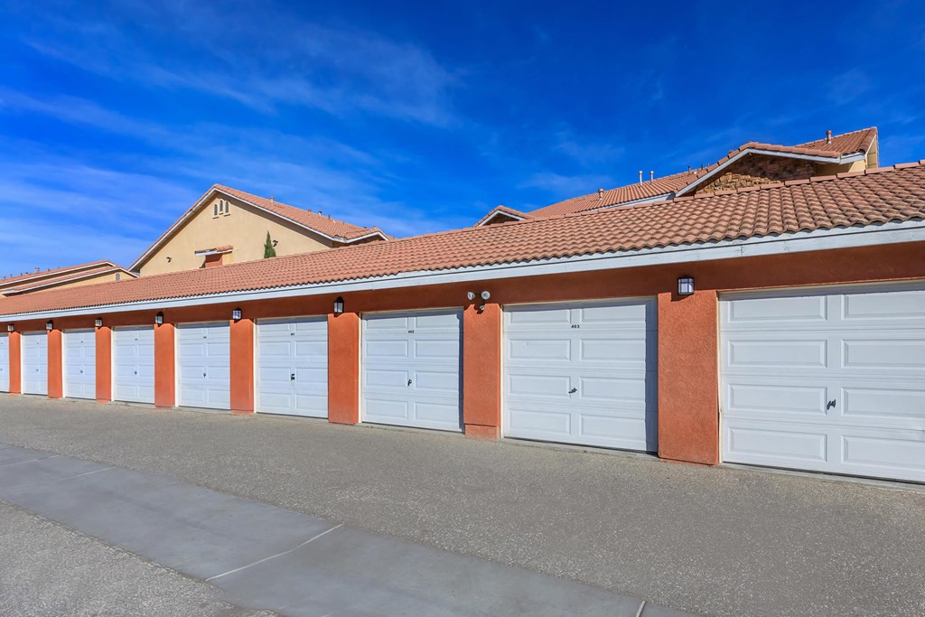a row of garages with white garage doors
