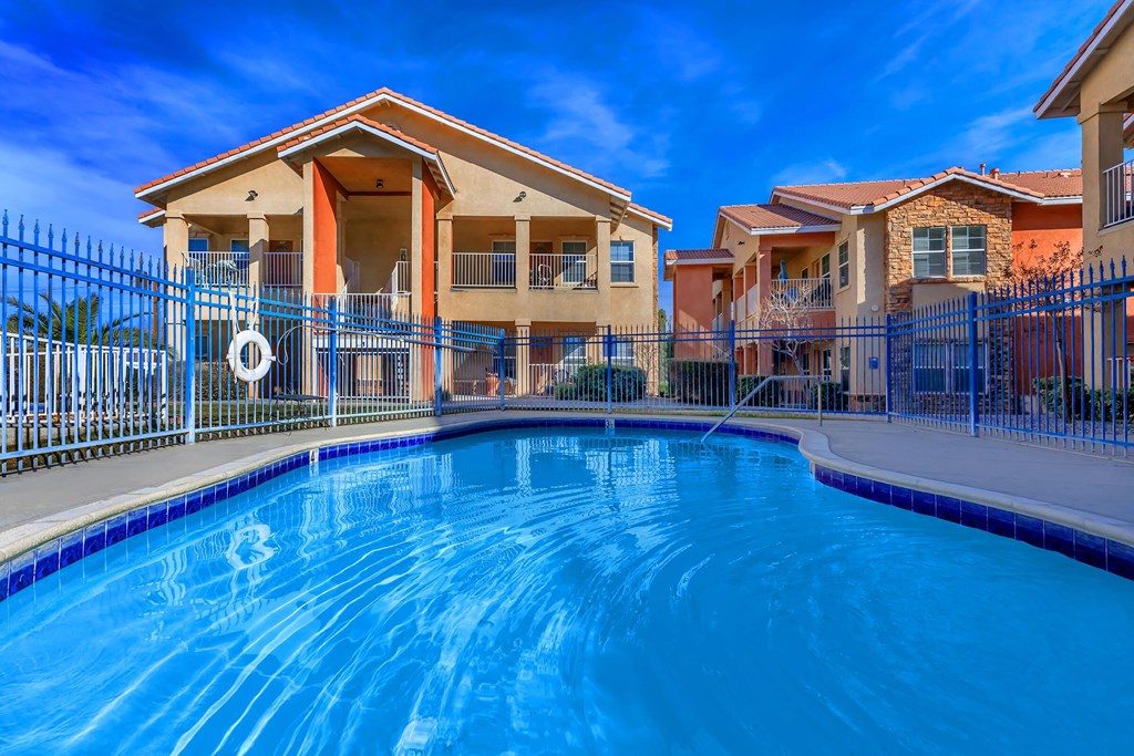a large swimming pool in front of a house