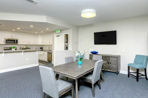 A dining room with a table and chairs.
