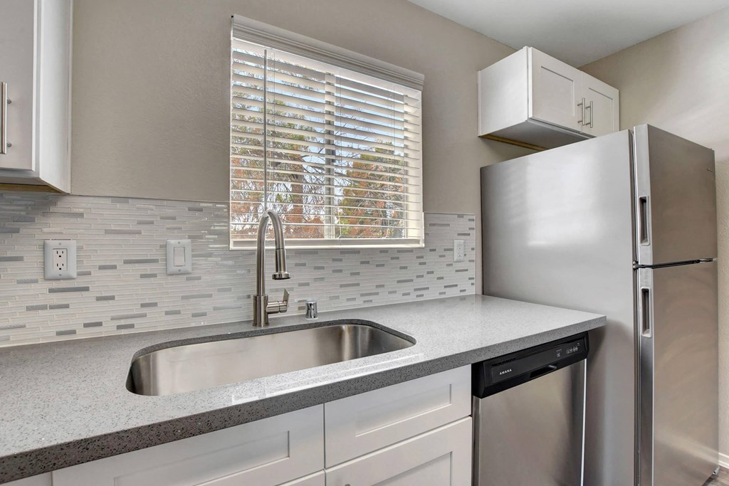 a kitchen with a sink and a refrigerator