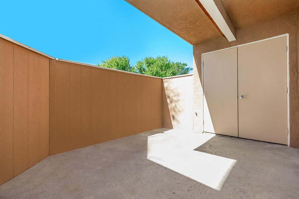 a garage with a door and a wall with a blue sky