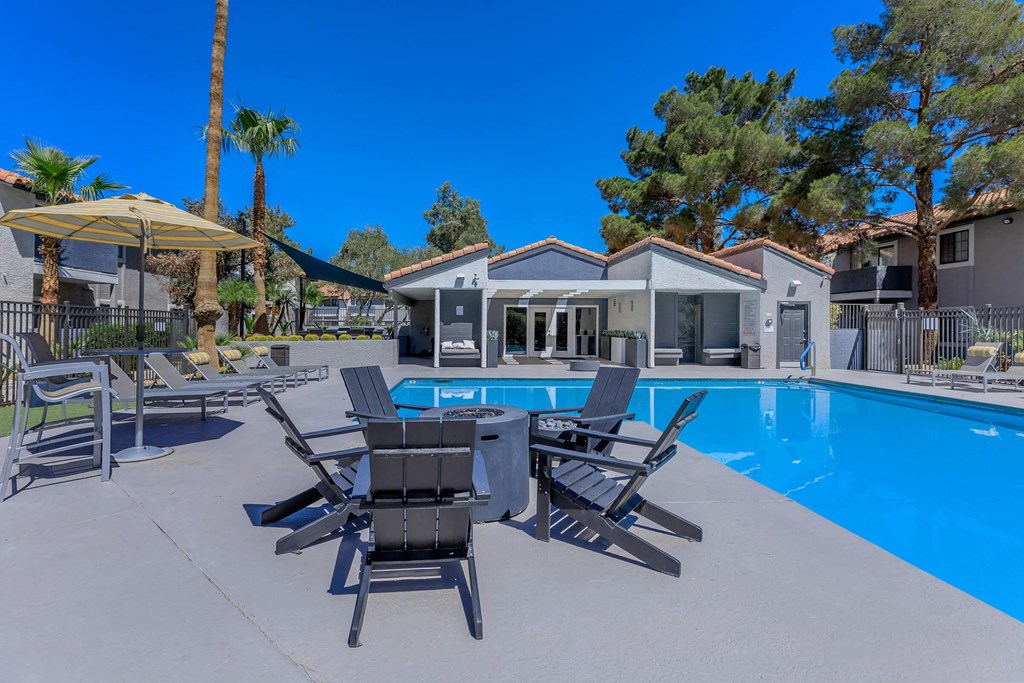 our apartments have a large swimming pool with chairs and tables