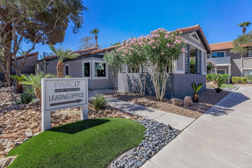 a house with a sign for a leasing office in front of it