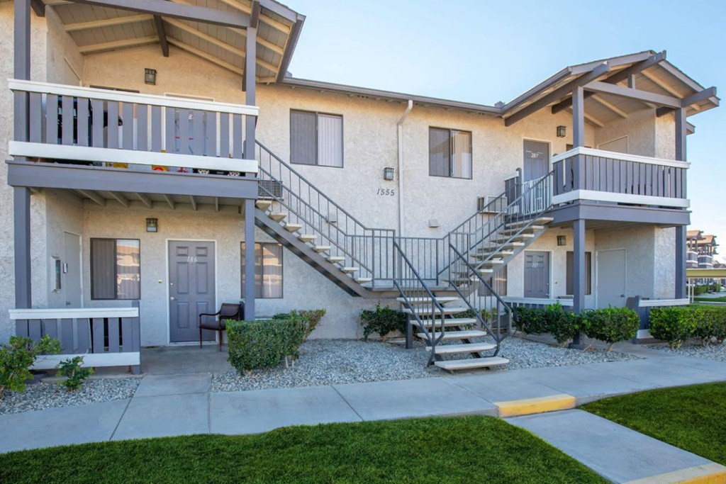 a building with two balconies and a staircase