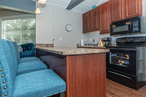 a kitchen with a counter top and a stove and a microwave