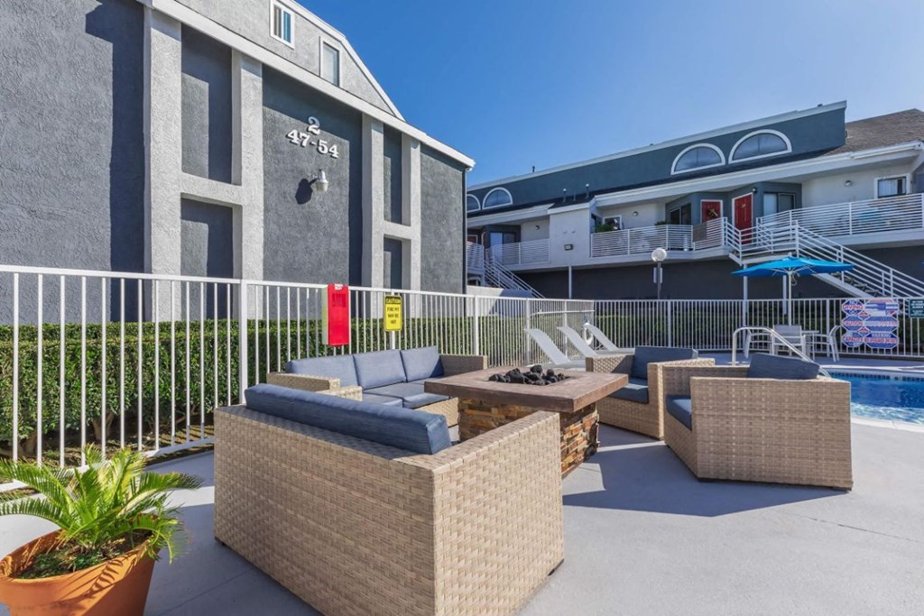 our apartments have a large patio with furniture and a pool