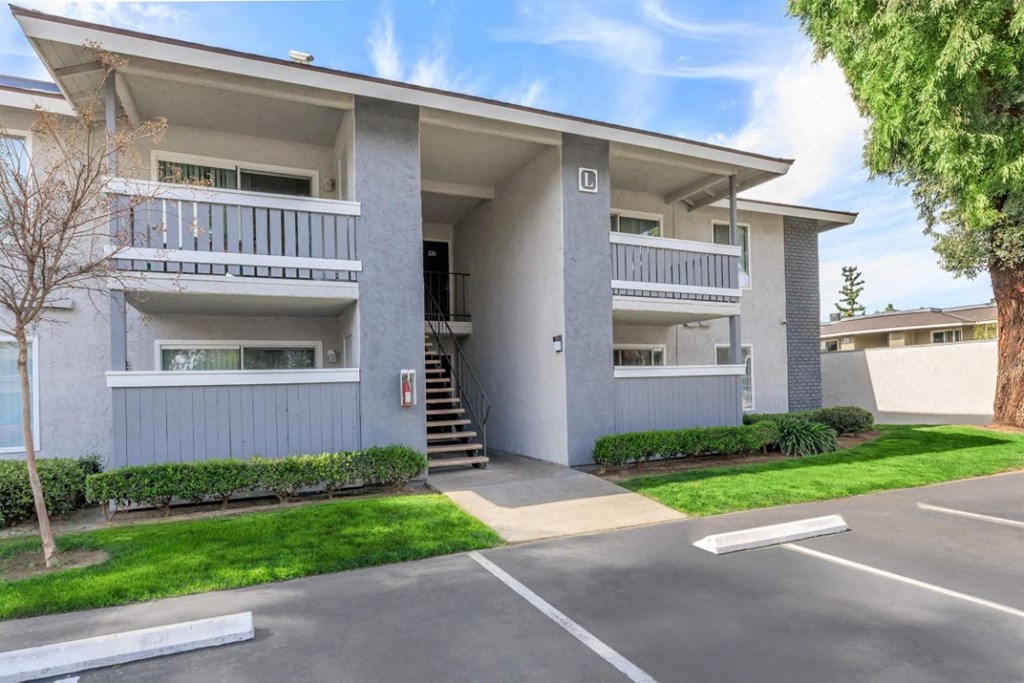 an apartment building with a driveway and stairs