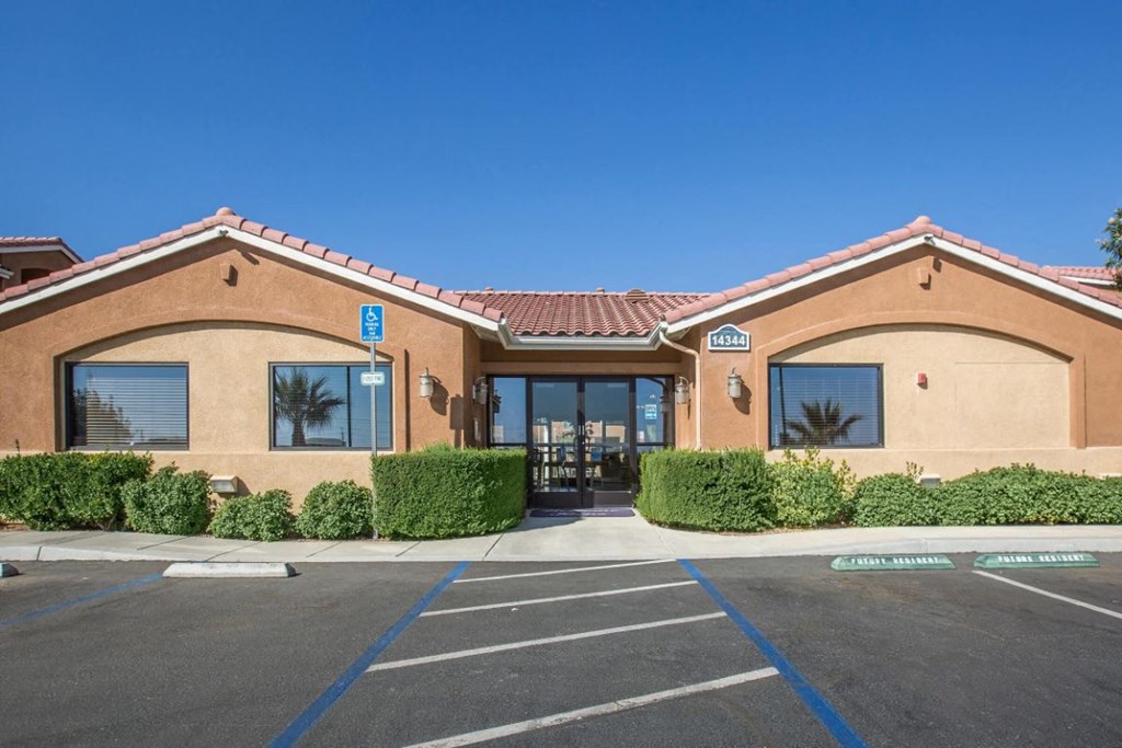 A building with a parking lot in front of it.