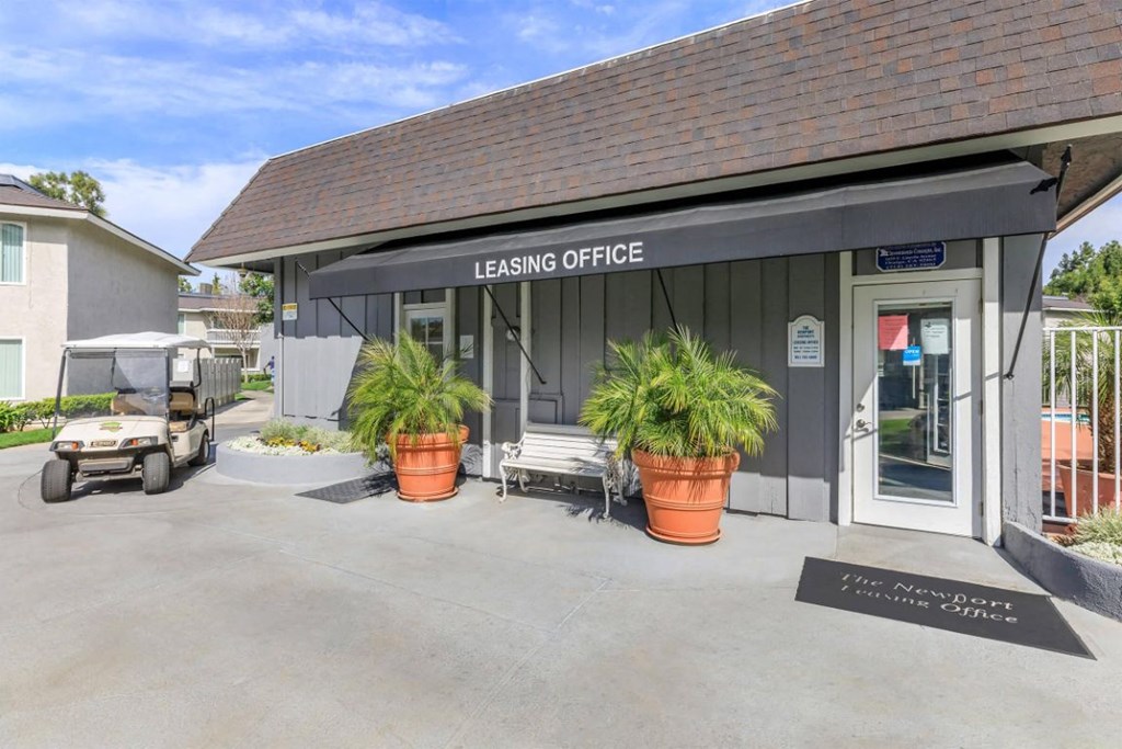 a building with a leasing office and a golf cart parked outside