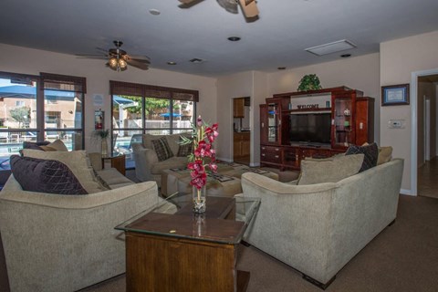 A living room with a couch, chair, and television.