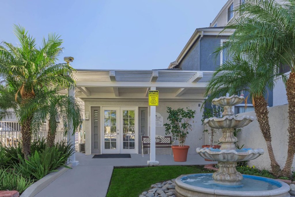 a house with a fountain in front of it