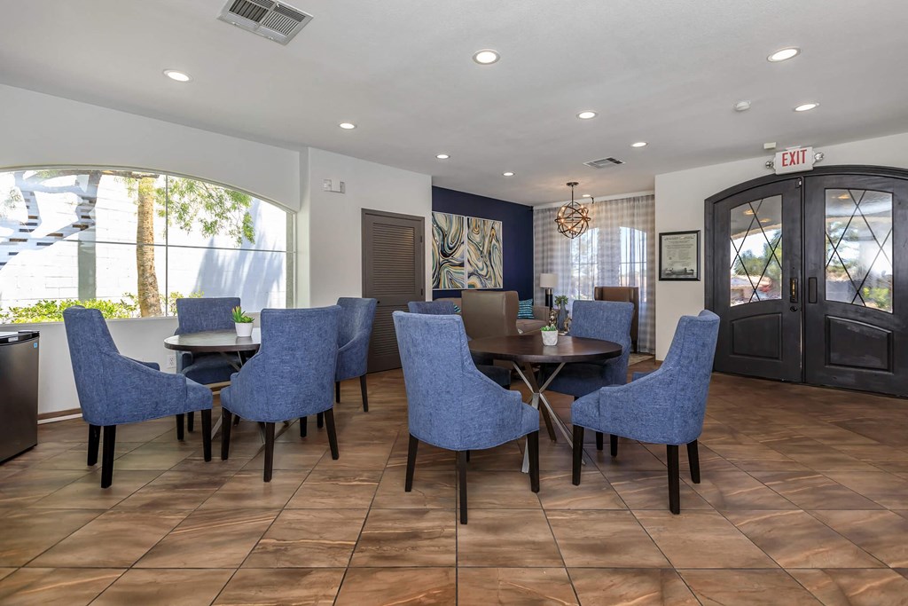 a dining room with blue chairs and a table