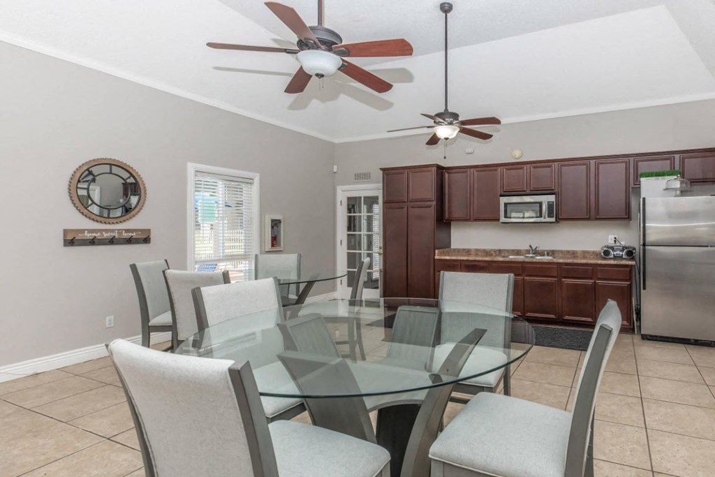 a dining room with a glass table and chairs